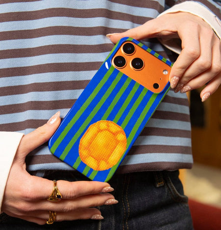 woman holding the best case for orange iPhone 17 Pro Max that complements its colours